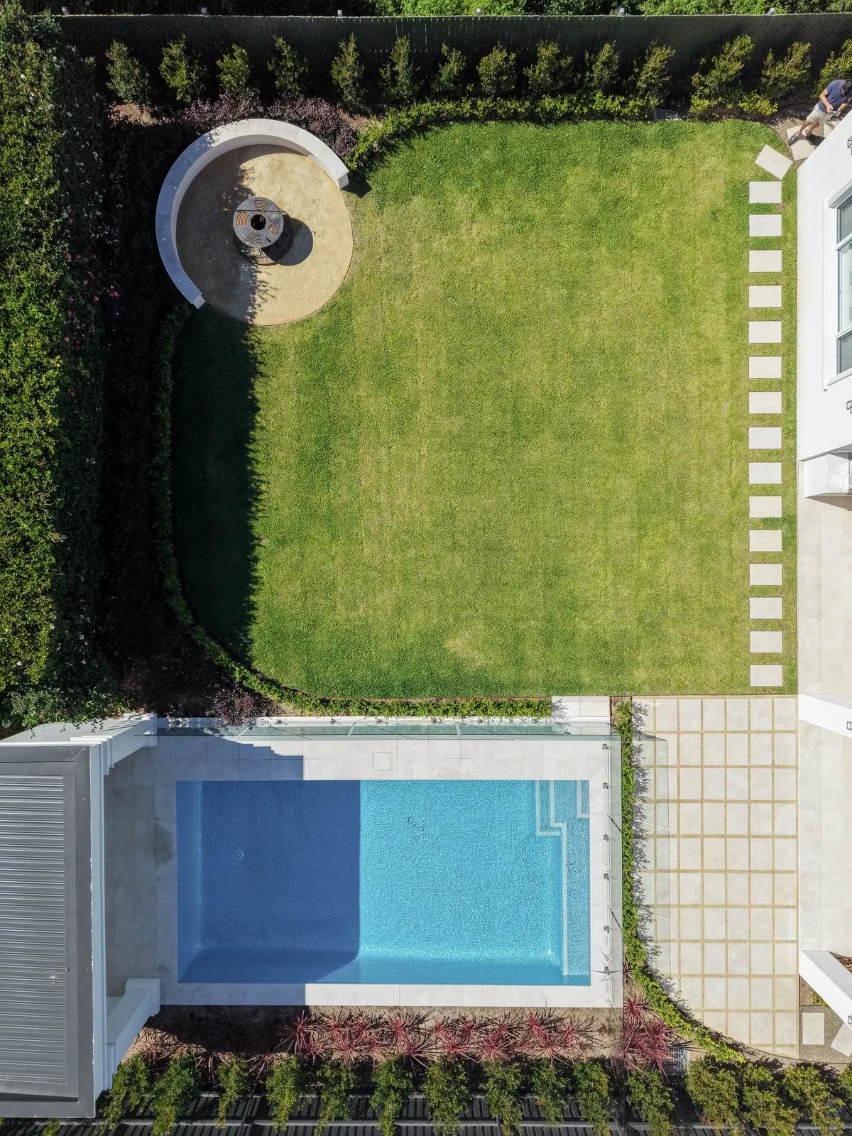 Aerial view of lawn, fire pit and pool in a Turramurra garden