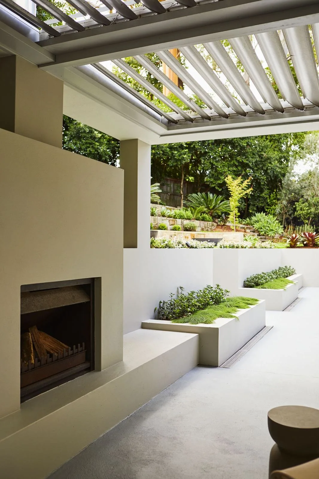 Outdoor fireplace under a louvred pavilion roof, Pymble
