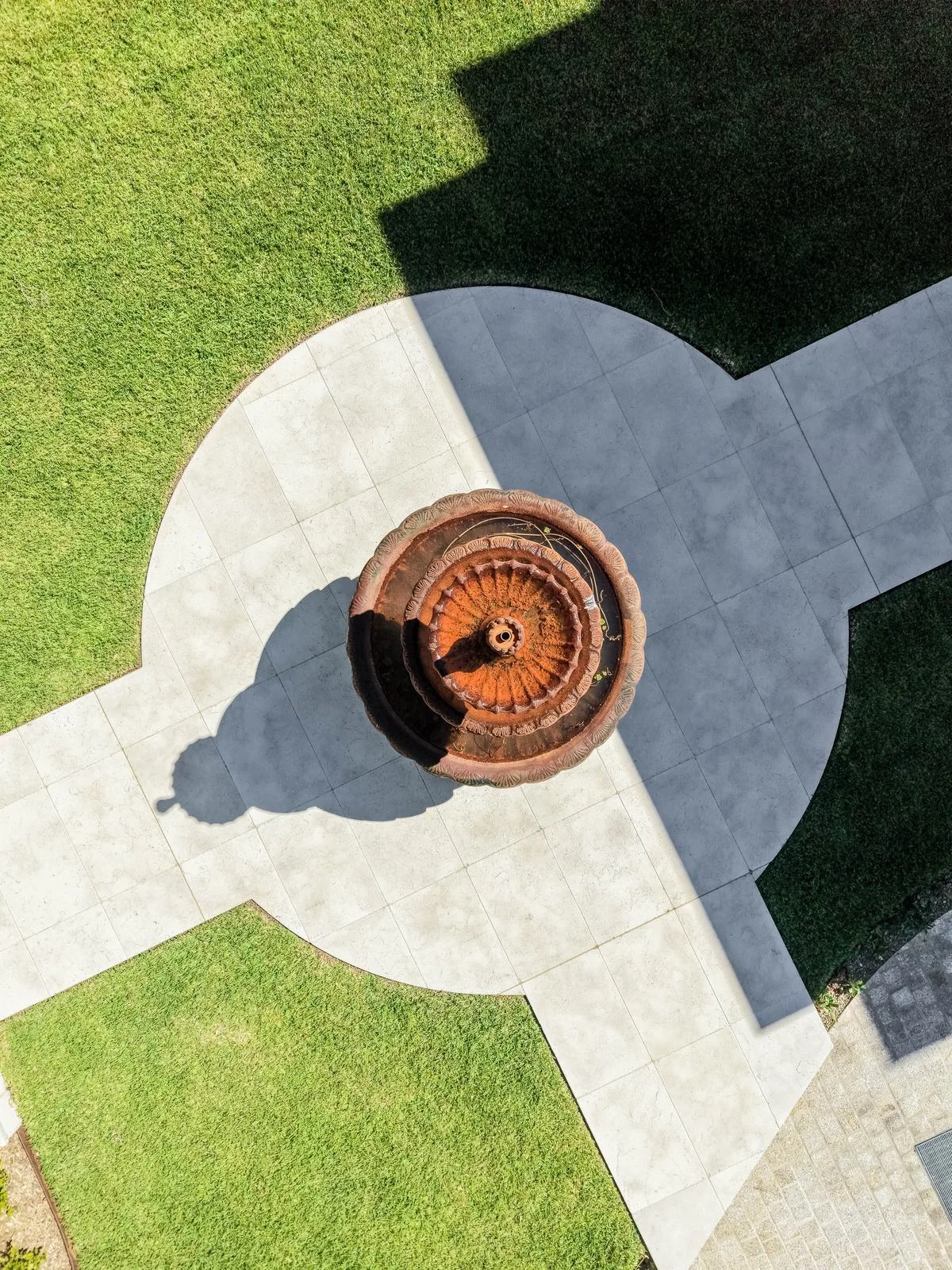 Aerial view of the circular fountain forecourt with radiating stone paths and lawn